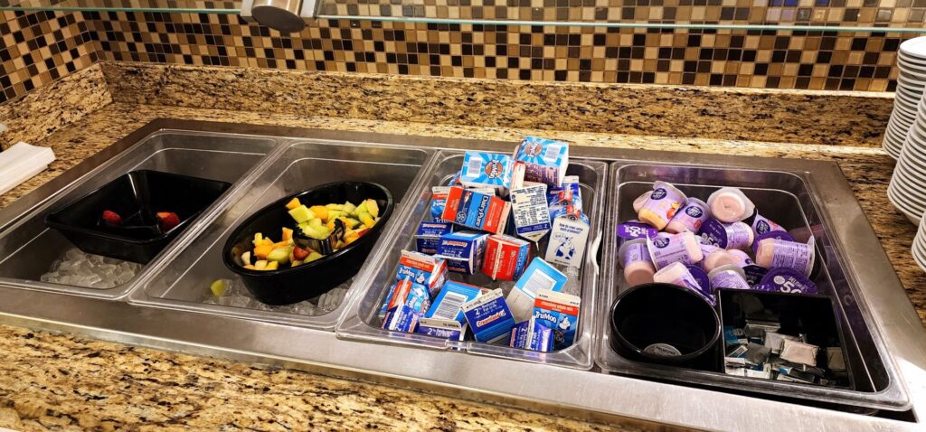 A tray of food and drinks on a counter in a hotel.
