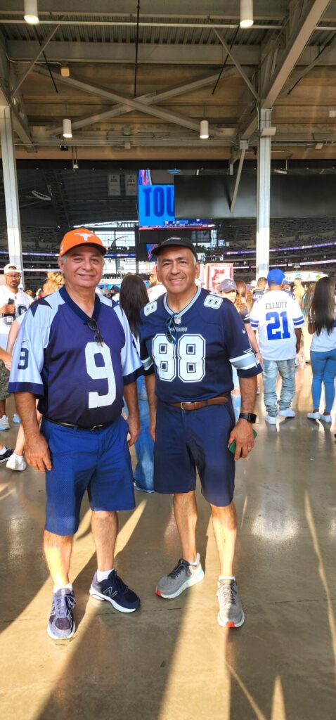 Two men posing for a picture in a stadium.