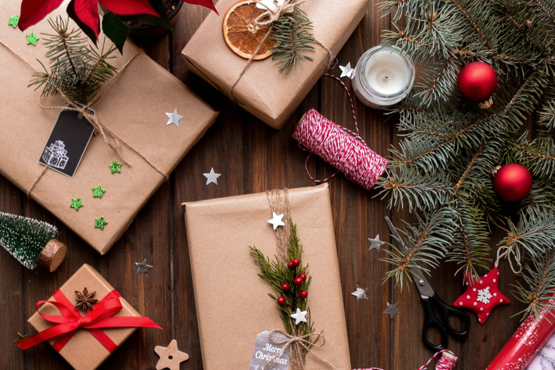 Christmas presents wrapped in brown paper on a wooden table in San Antonio.