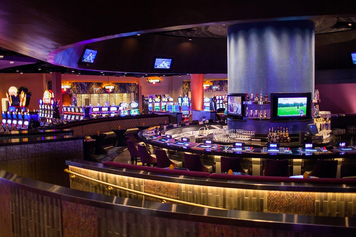 A casino bar with a large number of slot machines.