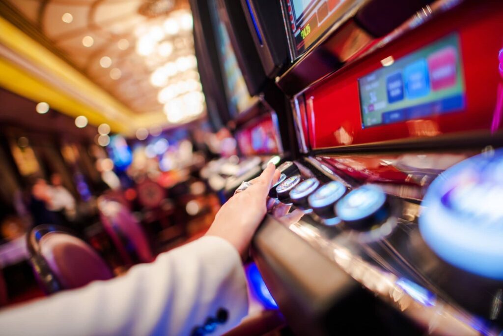 TPIxfbHI hand touching a slot machine